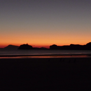 Mountain range in front of a red sunrise