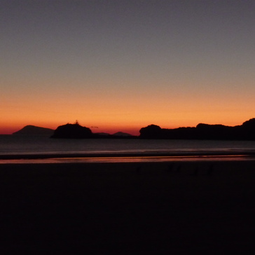 Mountain range in front of a red sunrise